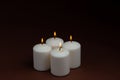 Four whiteÃÂ candlesÃÂ flameÃÂ burningÃÂ onÃÂ dark backgroundÃÂ withÃÂ copyÃÂ space forÃÂ text Royalty Free Stock Photo